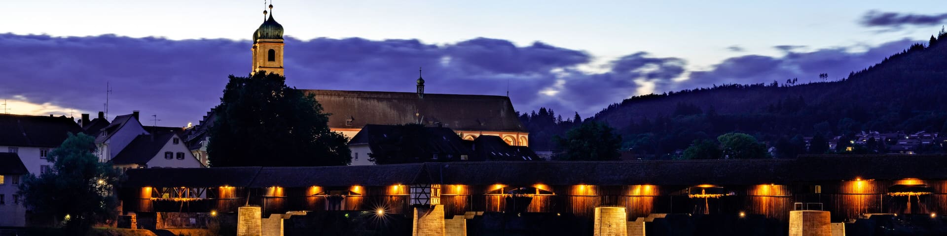 view of the St. Fridolin cathedral and Rhine bridge in Bad Saeckingen at sunset