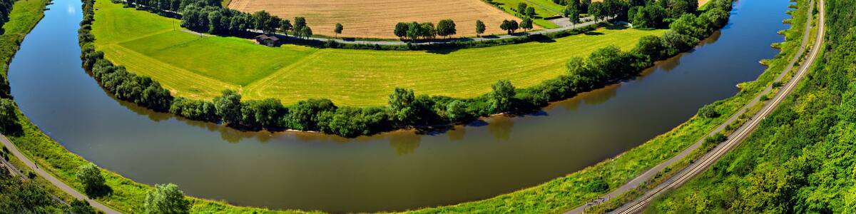 Aerial view of the river Weser between Beverungen and Karlshafen, Germany, with fields and meadows, trees and bushes on the river bank