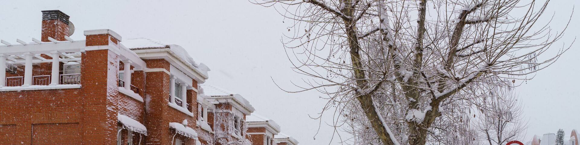 Streets and buildings covered in snow by day due to snowstorm Filomena falling in Madrid Spain