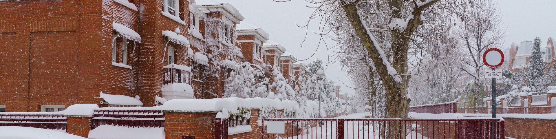 Streets and buildings covered in snow by day due to snowstorm Filomena falling in Madrid Spain