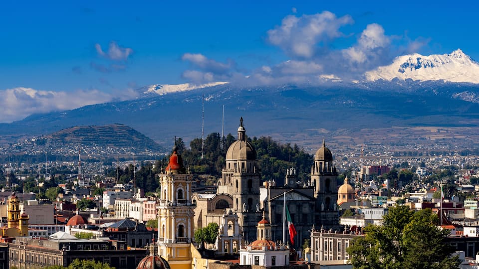 Toluca colonial cathedral and historic downtown with snow-capped Nevado de Toluca volcano under clear blue sky, State of Mexico, Mexico