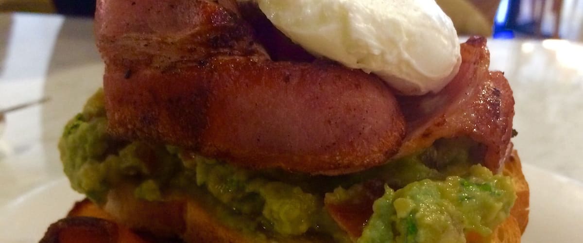 Yummy smashed avo poached egg and maple bacon $20+