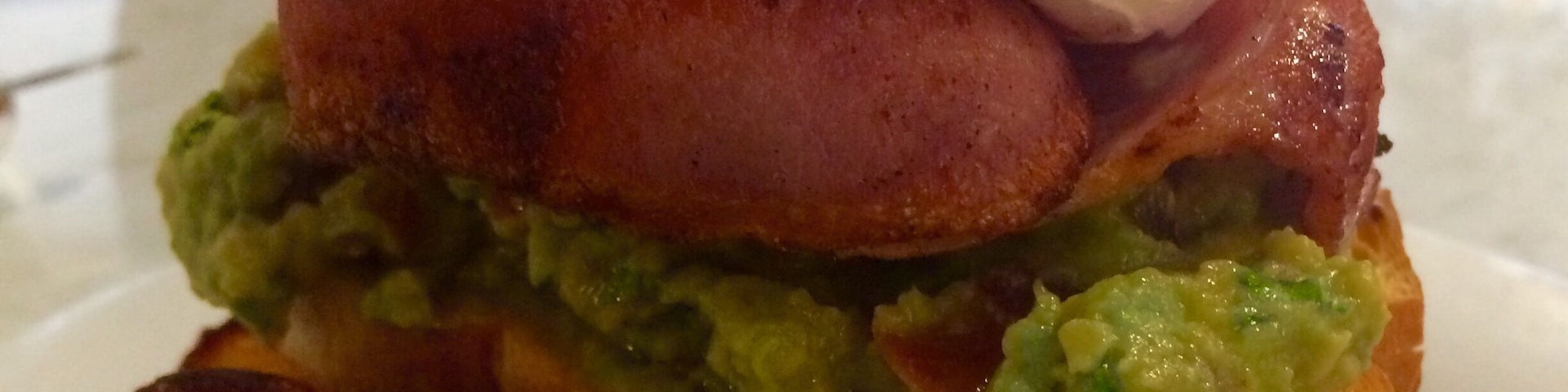 Yummy smashed avo poached egg and maple bacon $20+