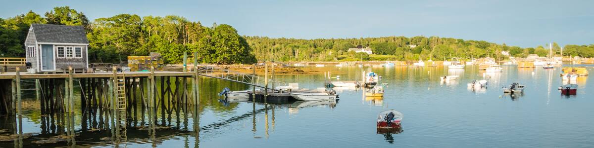 Lobster boats are moored in the harbor at dusk in Friendship, Maine