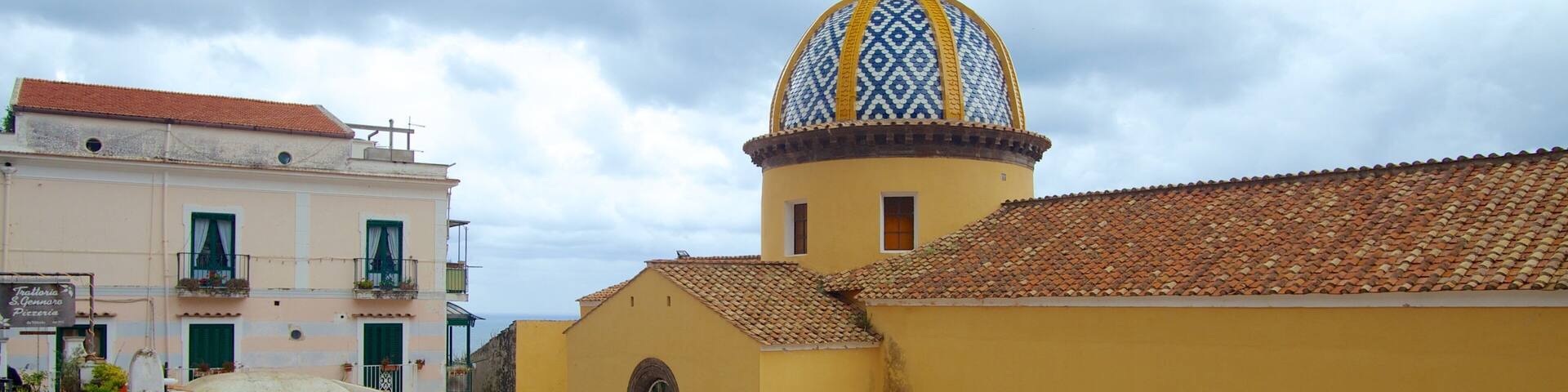 Praiano which includes a church or cathedral and a city