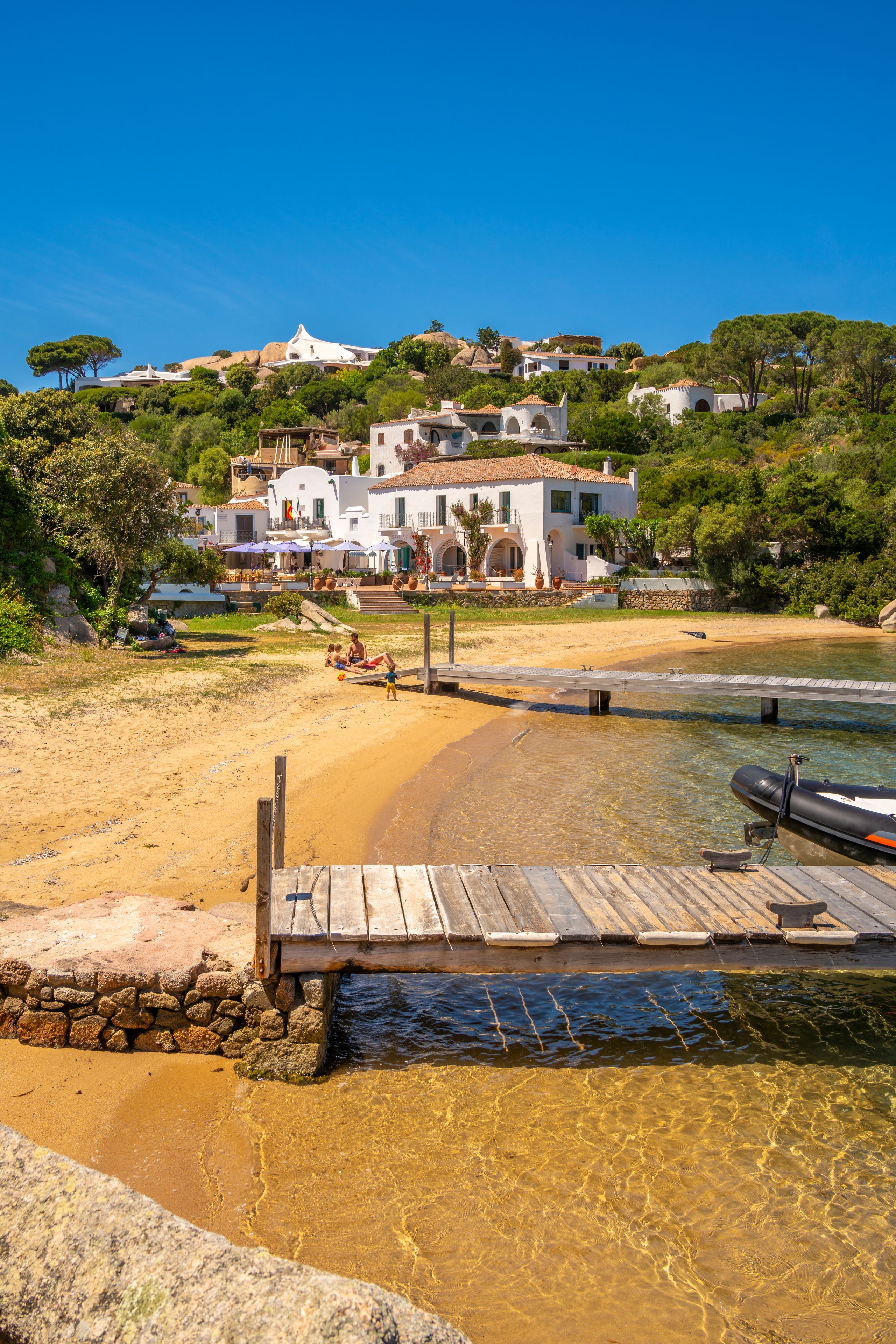 View of beach and whitewashed villas of Porto Rafael, Sardinia