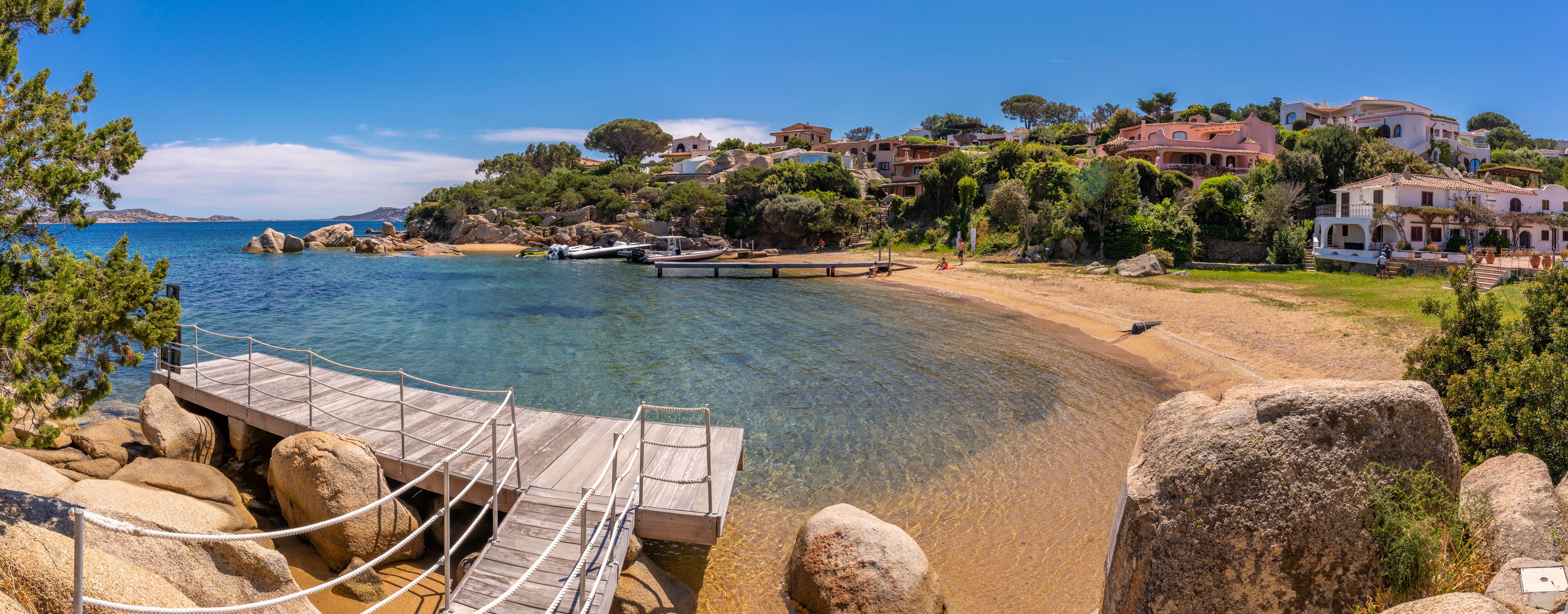 View of beach and whitewashed villas of Porto Rafael, Sardinia