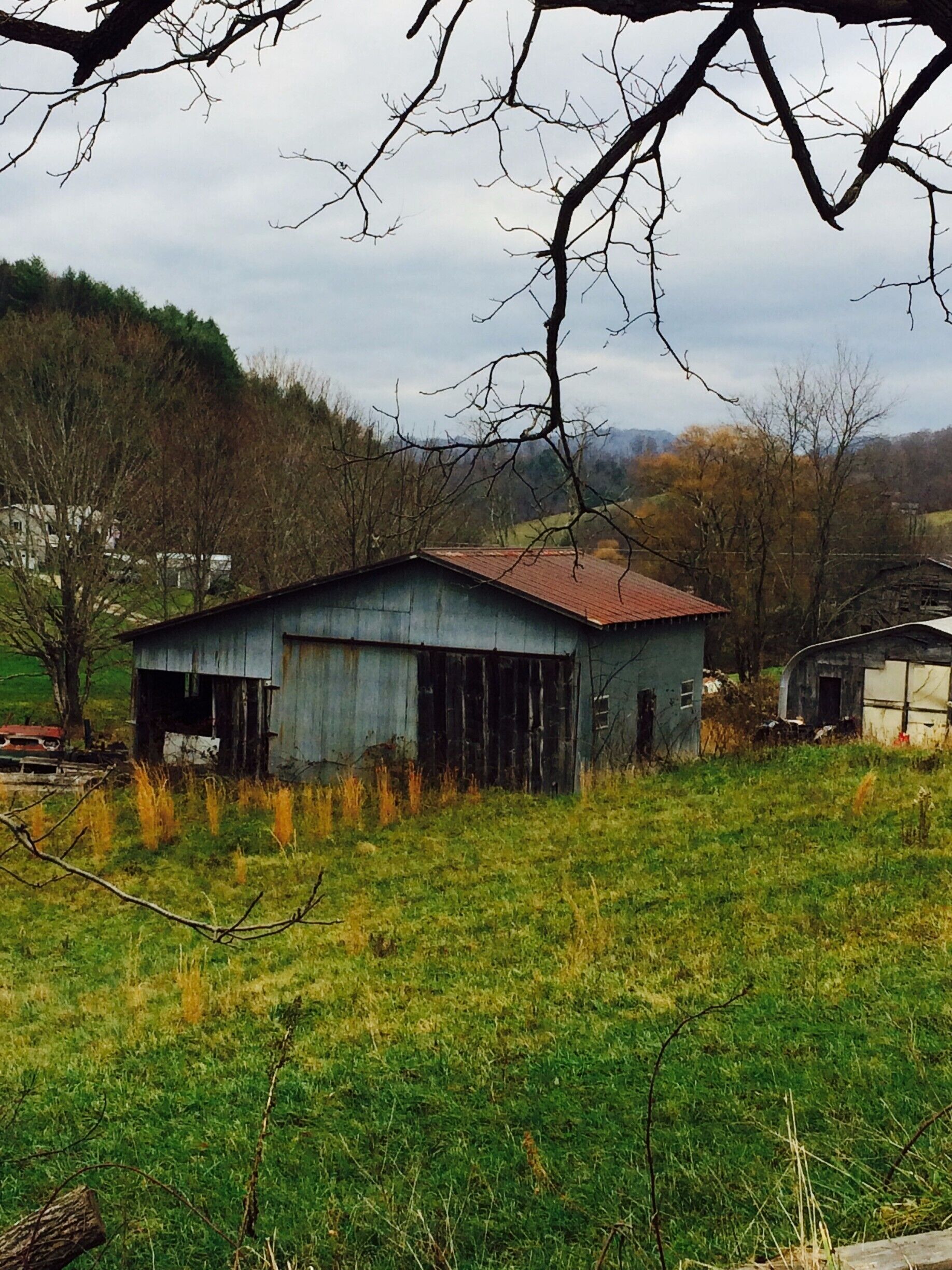 This image is of my neighbor’s property. I live out in Vilas, NC. You will need to drive down towards mountain city on highway 105. The rugged torn down barn with a rusted roof and the old rusted front half of a car in the picture reminds me of the long lost Appalachian farming. Out in the distance you can see a modern home. For me this picture represents the old and new Appalachia co existing side by side. Appalachia is modern yet old. Speaking of modern, there is a Dollar general across the street from this site. This picture shows the time locked aspect of the region. I liked this picture because it captures both the past and present in one frame. #appalachianechoes

