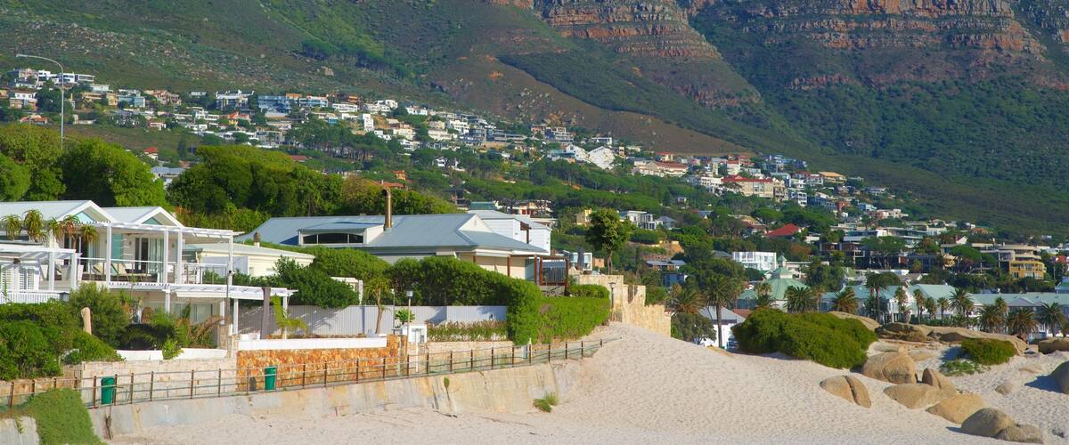 Camps Bay which includes a coastal town, a sandy beach and rocky coastline
