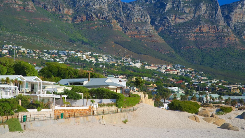 Camps Bay which includes a coastal town, a sandy beach and rocky coastline