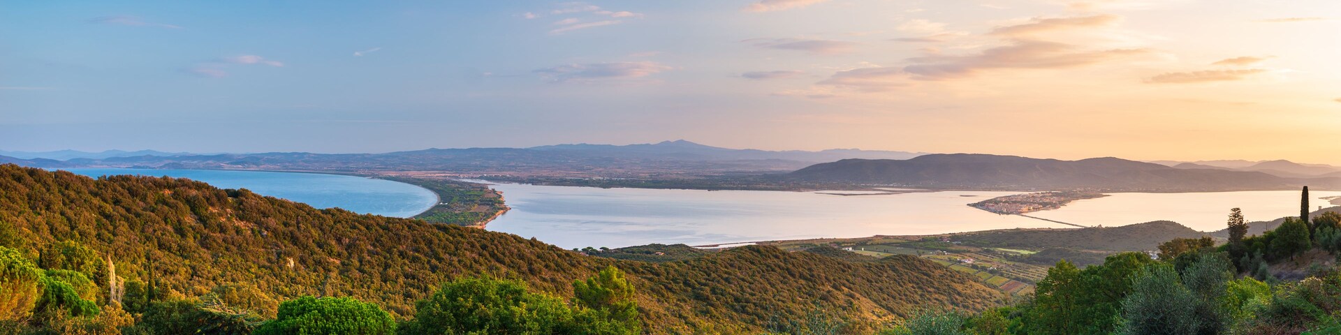Sunrise landscape at Orbetello lagoon natural park, beautiful sky scenic coast aerial view from Monte Argentario, tourism destination Tuscany Italy
