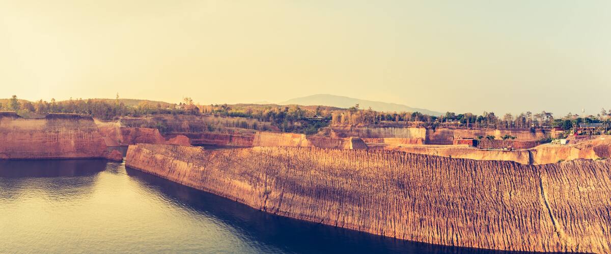 A dam with a reservoir, a bridge, and a distant mountain range.