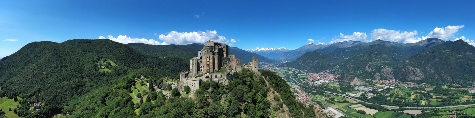 The Sacra di San Michele (Saint Michael's) Abbey, Turin, Italy, shot aerial with mountains of Susa valley in background. Aerial view