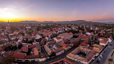 Aerial sunset view of Szentendre, charming touristic small town in Hungary near the Danube, Orthodox Greek church, colorful dramatic sky