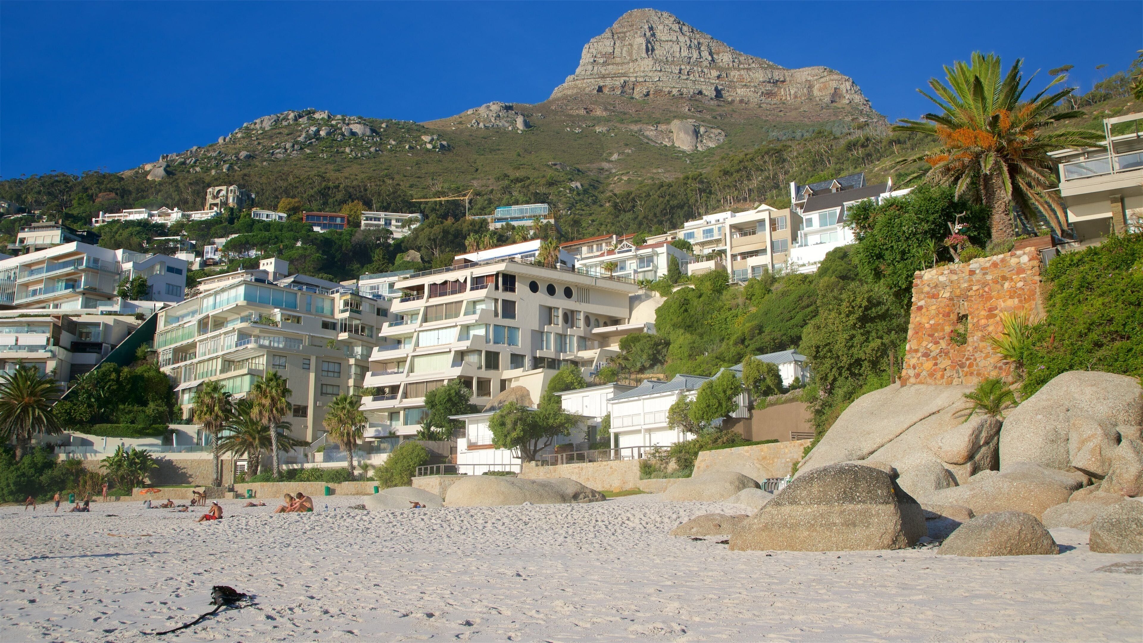 Clifton featuring a sandy beach and a coastal town