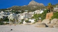 Clifton featuring a sandy beach and a coastal town