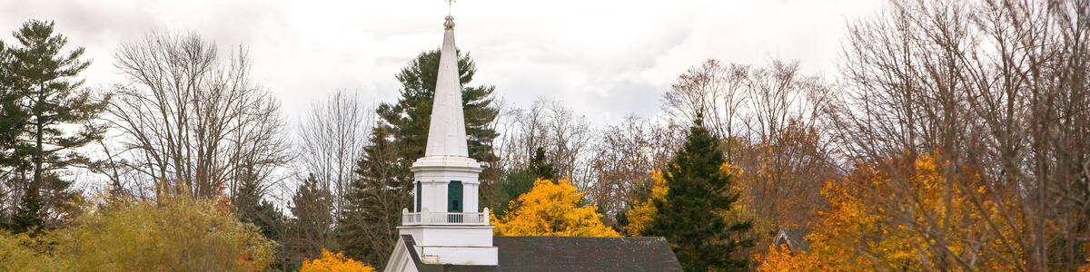 Orland United Methodist church with trees showing fall colors, Orland, Maine.