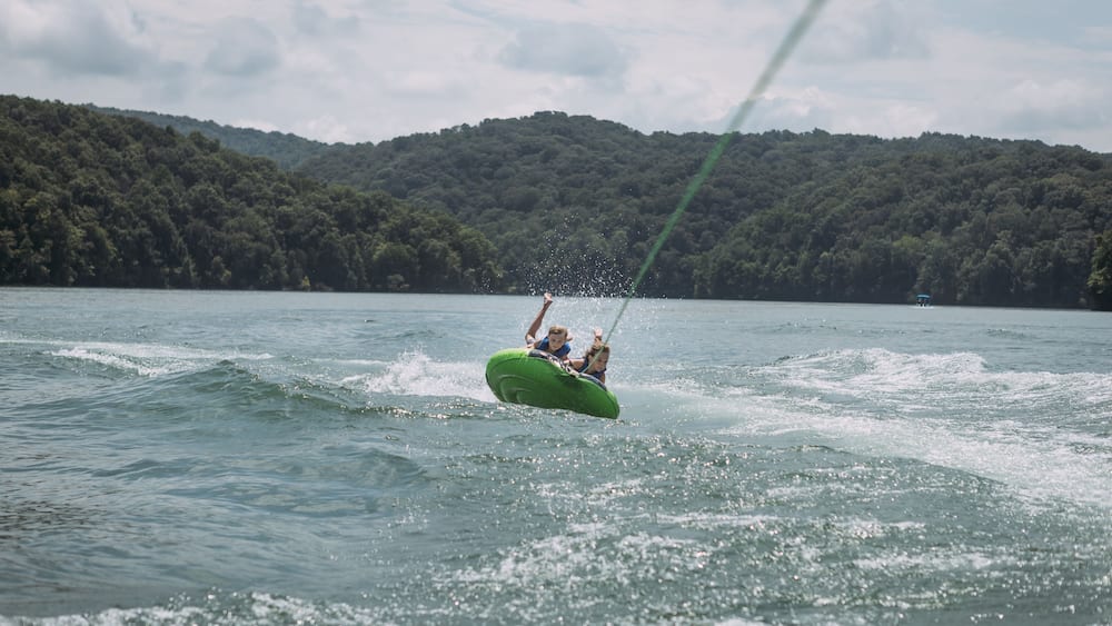 Kids being pulled behind speedboat on innertube on Dale Hollow L