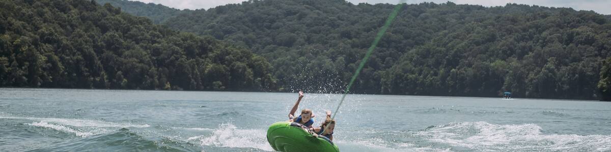 Kids being pulled behind speedboat on innertube on Dale Hollow L