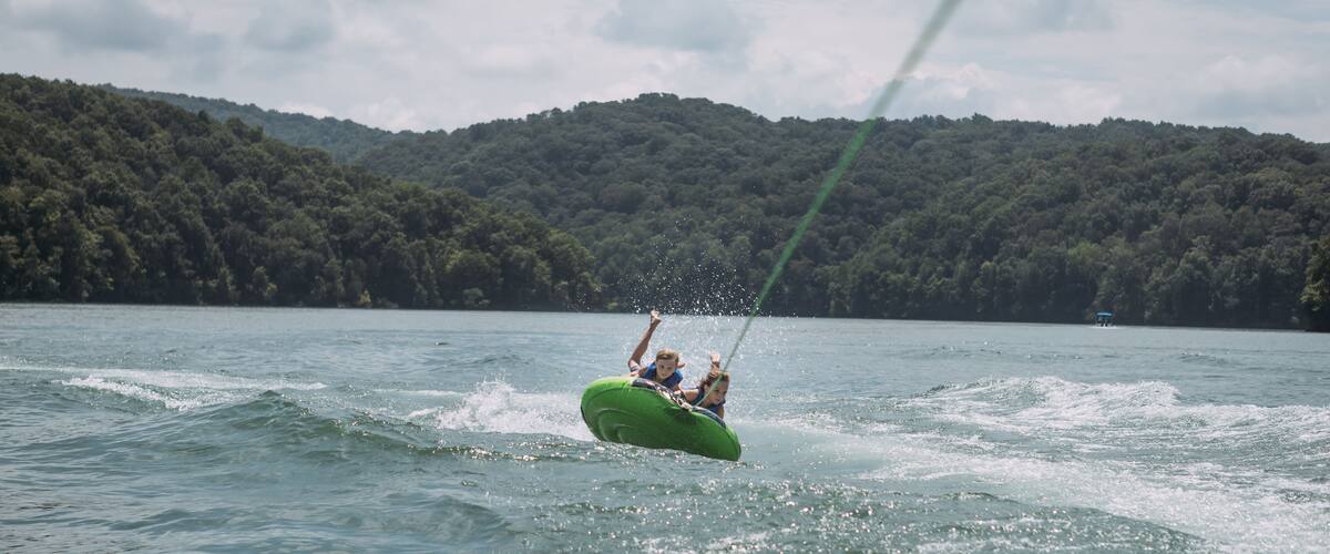 Kids being pulled behind speedboat on innertube on Dale Hollow L