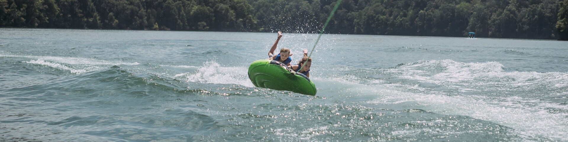 Kids being pulled behind speedboat on innertube on Dale Hollow L