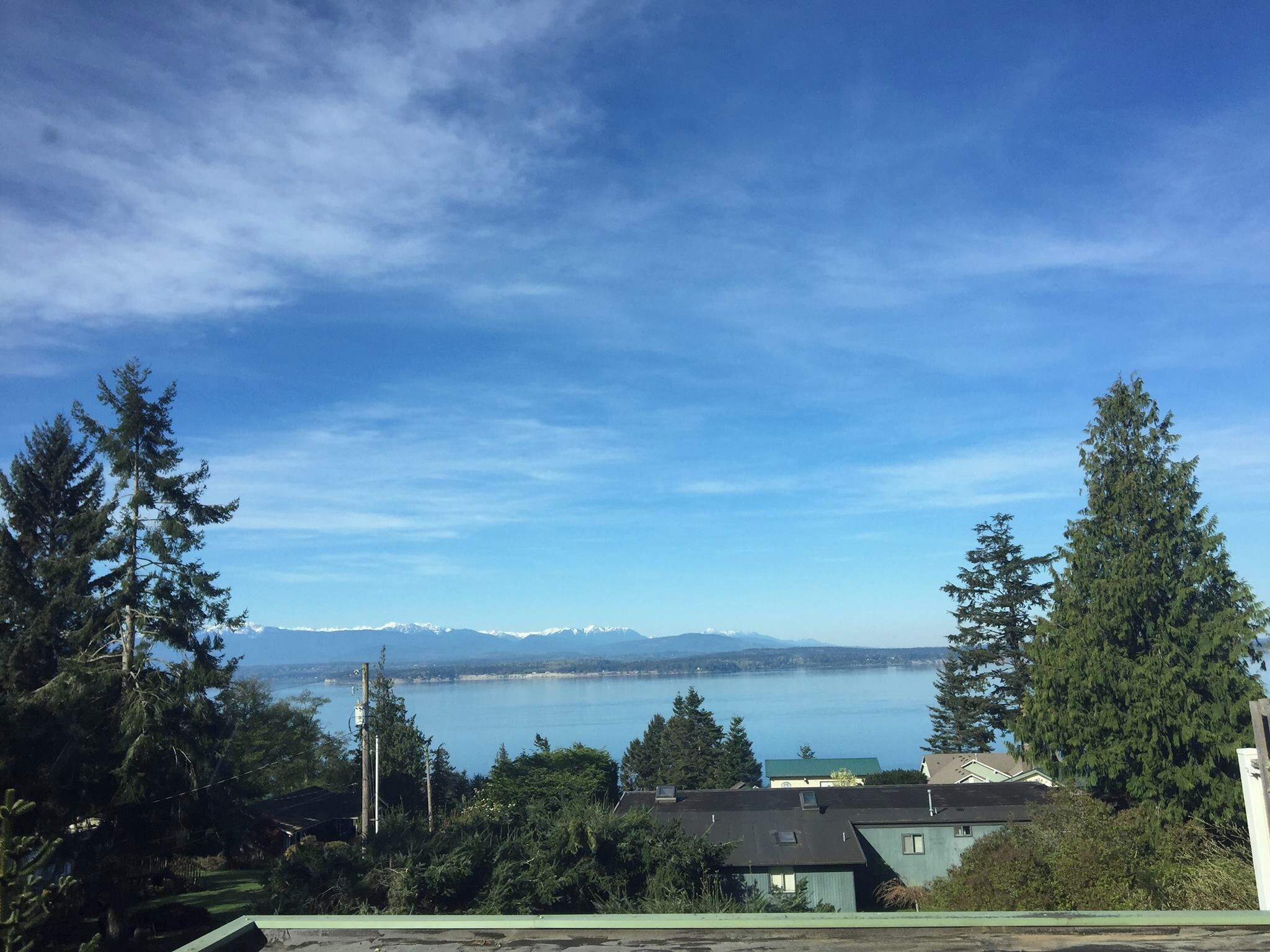 This view of Marrowstone Island and the inland passage, awash with ships from China plying through peaceful Puget Sound waters, inspires from the fourth floor balcony of a Japanese-style bed 'n breakfast on Whidbey Island.