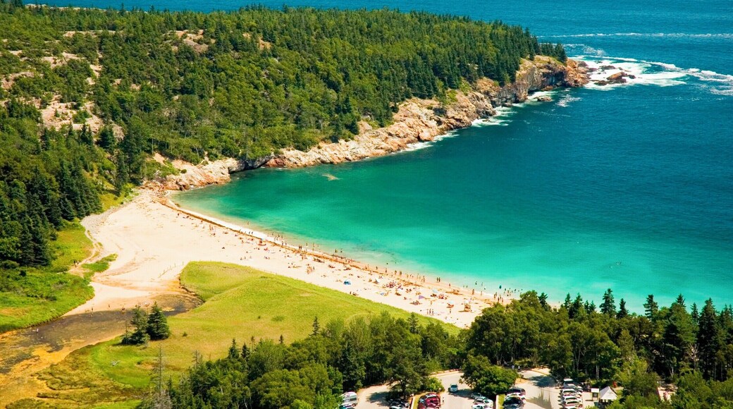 A crowd of beach go-ers enjoy the summer sun in Acadia National Park, Maine, USA. Being from the south, we thought it was too cold to swim in the ocean so we opted for a hike instead. Luckily, we stumpled upon a freshwater lake on our hike that was a bit warmer than the ocean. The view over the beach was amazing! #waterlust