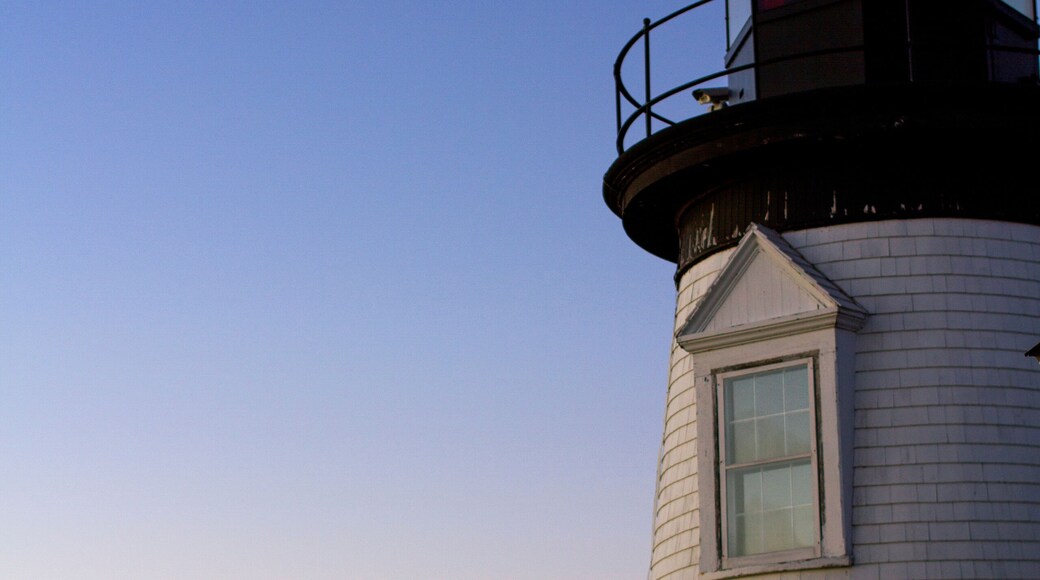 Low angle view of Prospect Harbor Point Light against sea and dramatic sky during sunset