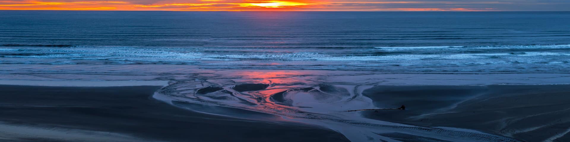 USA, Washington State, Copalis Beach. Sunset panoramic where Boone Creek enters Pacific Ocean.