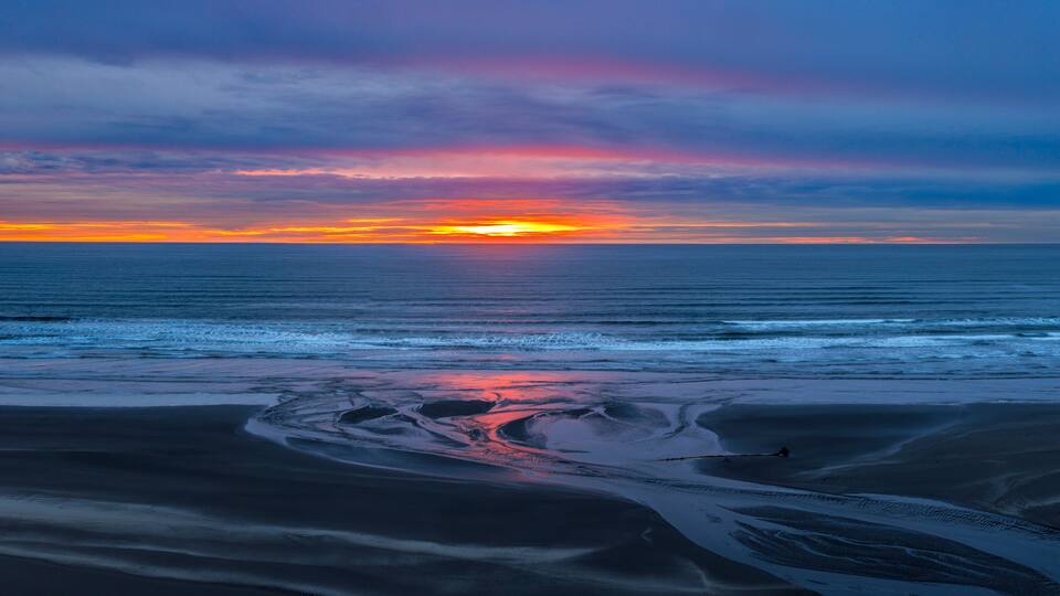 USA, Washington State, Copalis Beach. Sunset panoramic where Boone Creek enters Pacific Ocean.