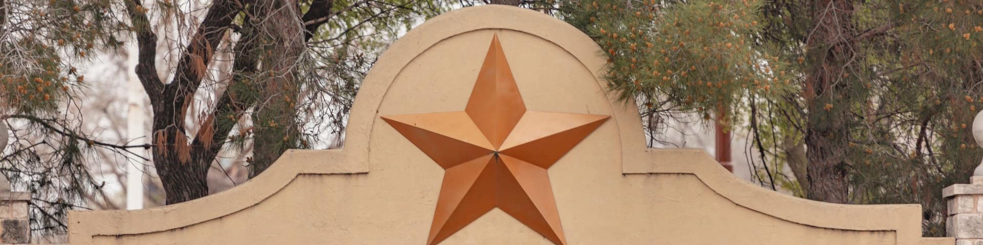 A sign with 'SIX FLAGS OVER TEXAS' and a star above it.