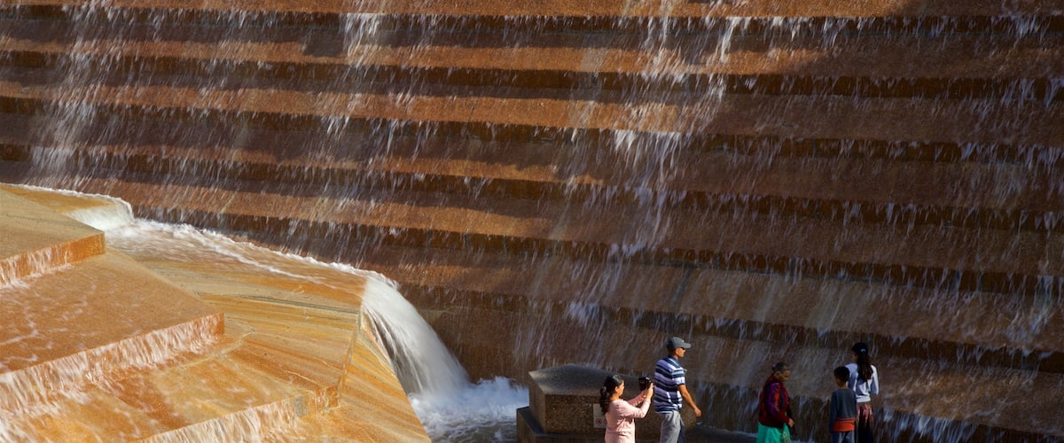 Fort Worth Water Gardens which includes a fountain as well as a small group of people