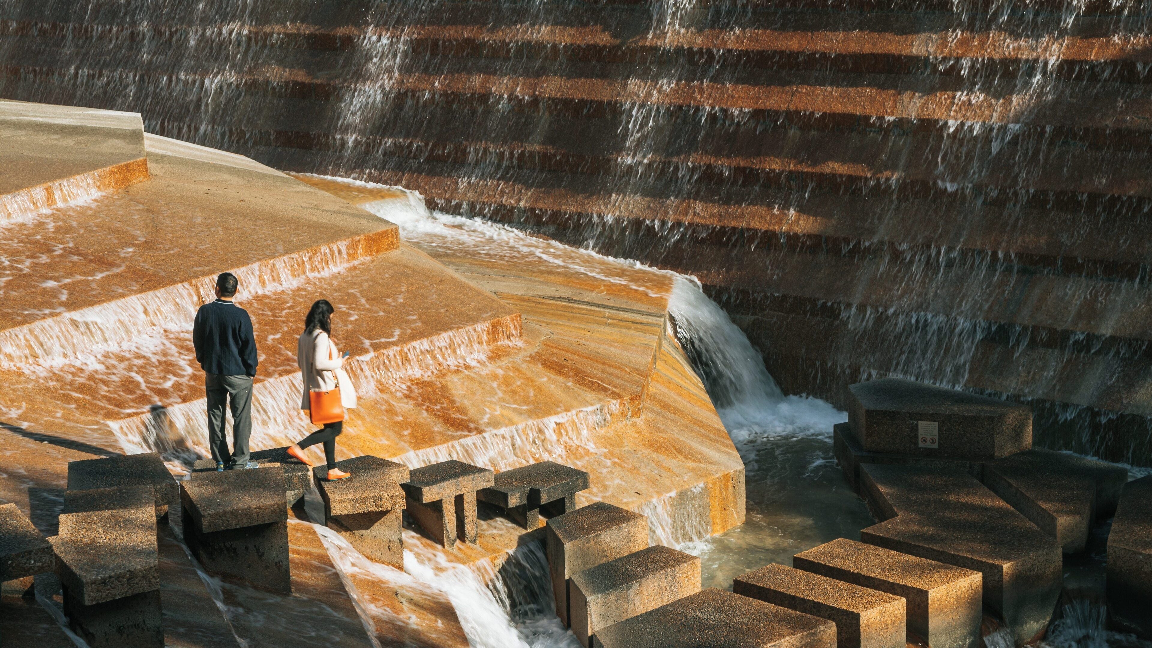 Exploring the tranquil beauty of Fort Worth Water Gardens in Downtown Fort Worth, Texas, during a sunny day with cascading water features and picturesque surroundings