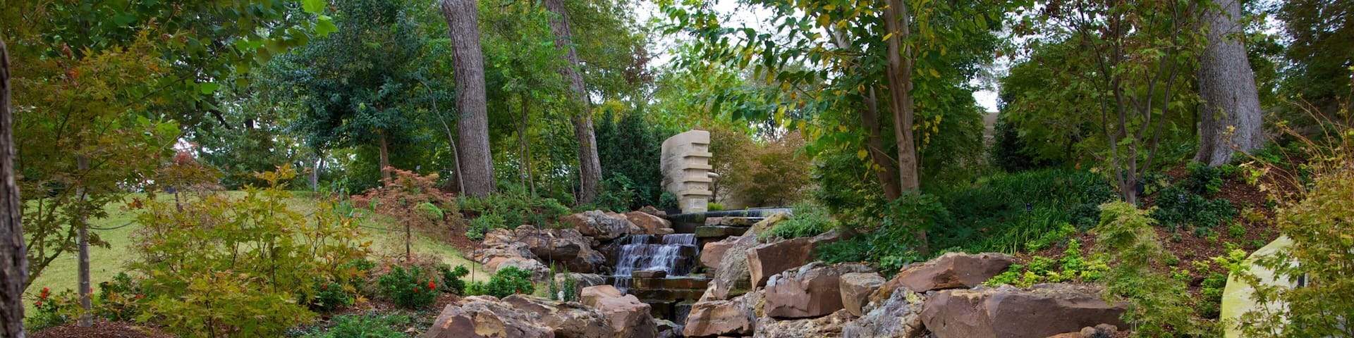 Beautiful rock formations and flowing water create a serene atmosphere in Dallas Arboretum