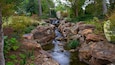 Beautiful rock formations and flowing water create a serene atmosphere in Dallas Arboretum