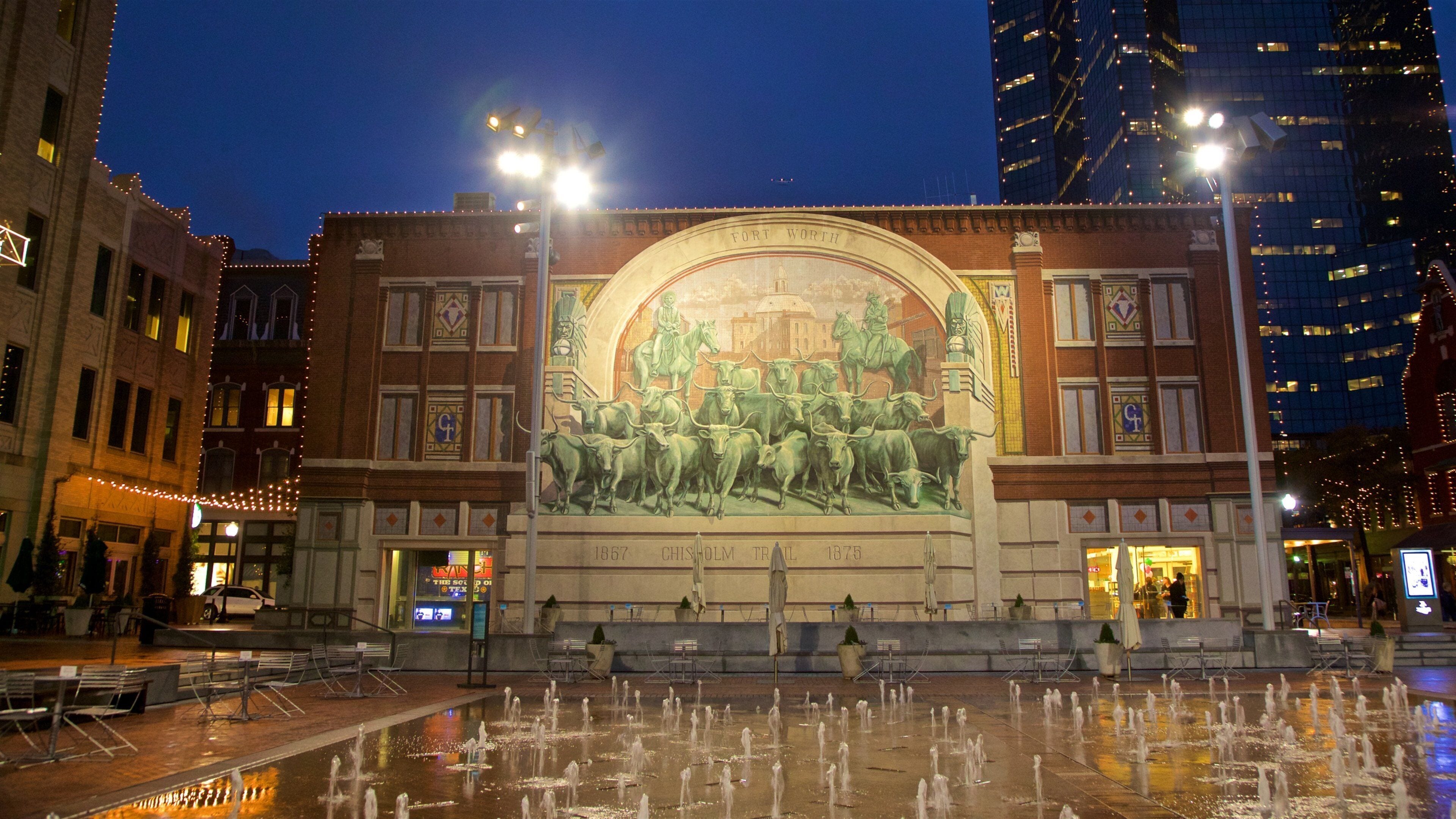 Sundance Square which includes a fountain, night scenes and outdoor art