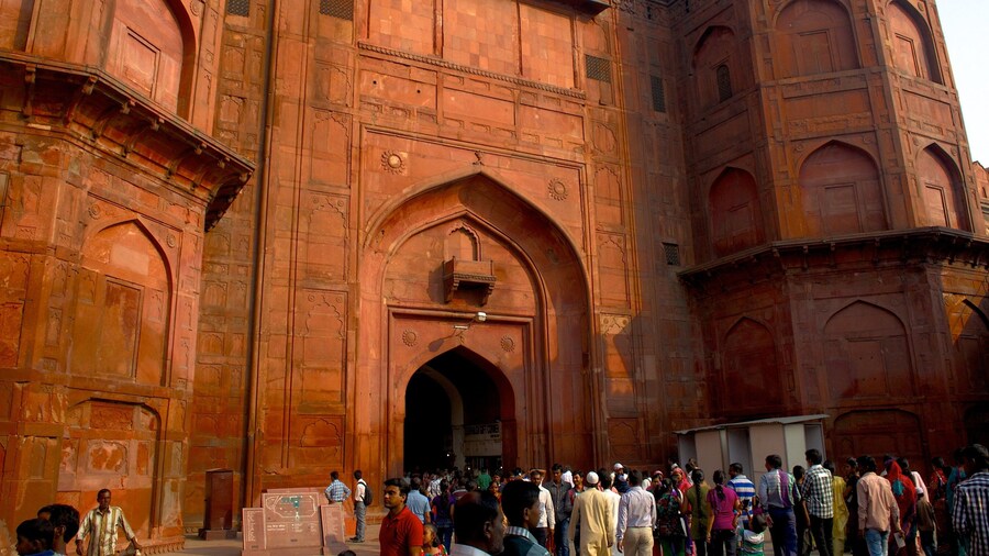 Red Fort showing a castle and heritage architecture as well as a large group of people