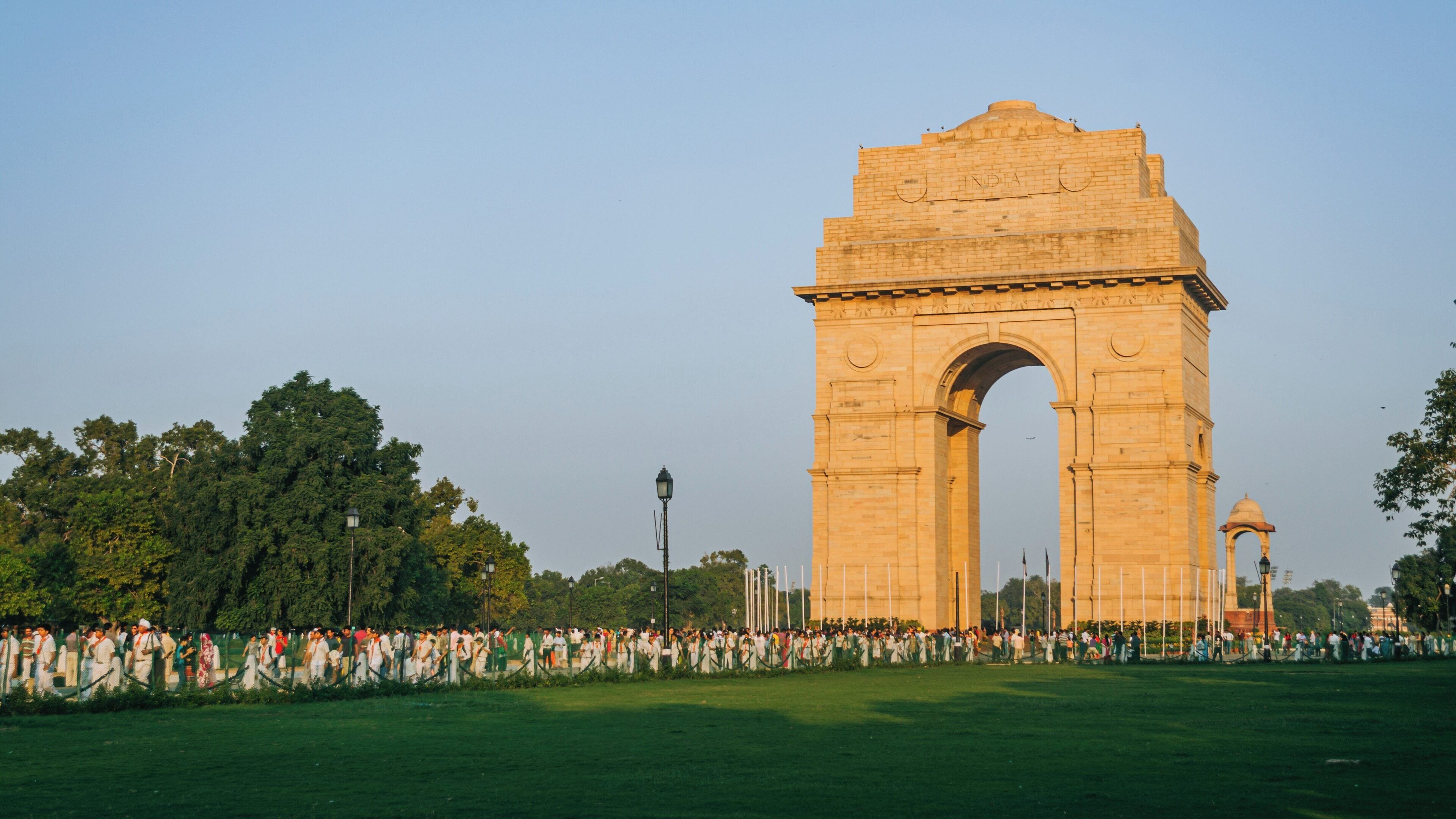 Crowds gather at India Gate in Chanakyapuri, New Delhi, enjoying the serene atmosphere during evening hours