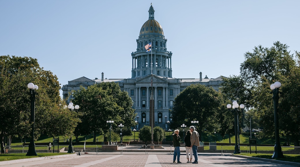 Colorado State Capitol Building showing a park and heritage architecture as well as a small group of people