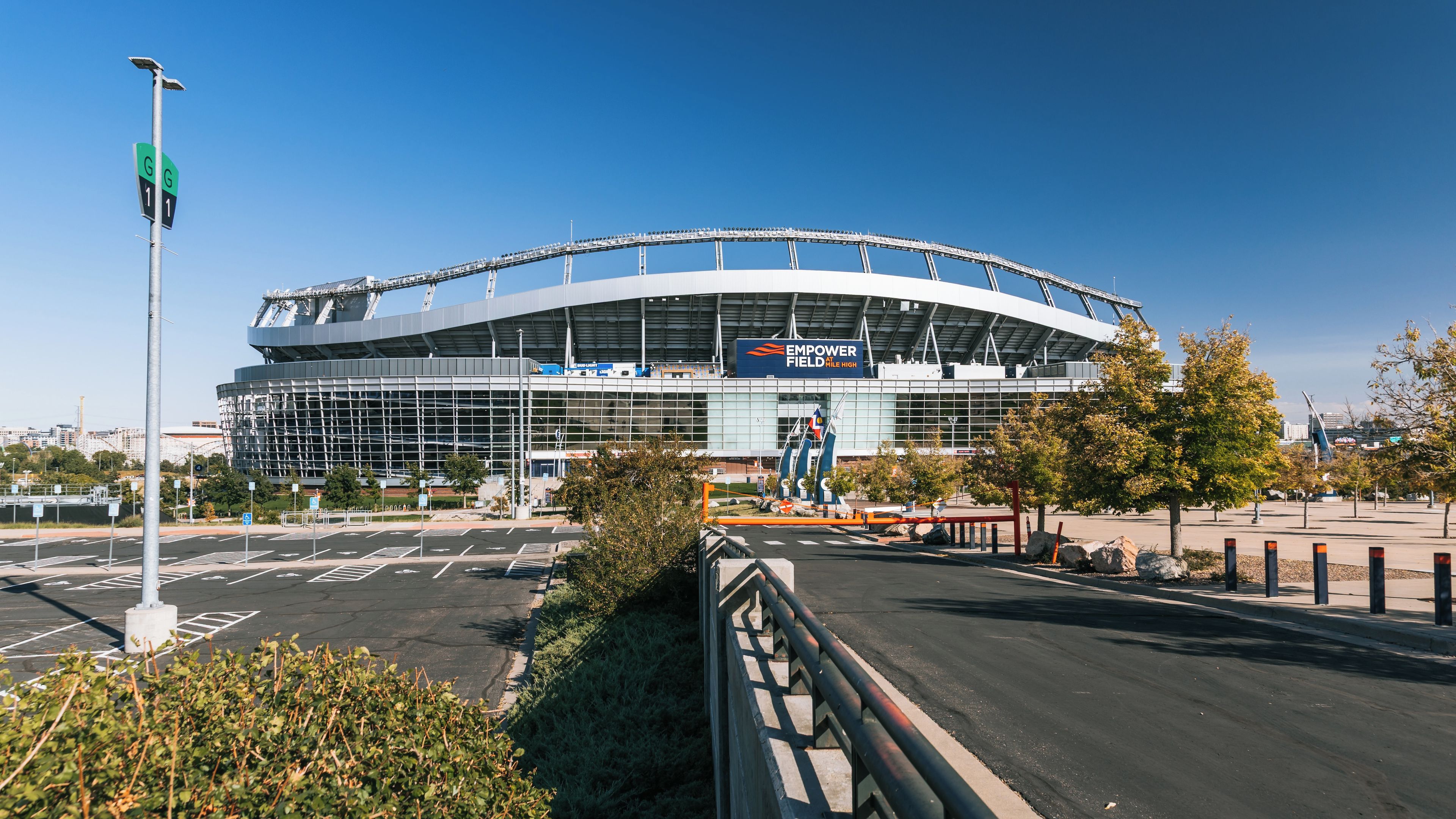 A large stadium with a curved roof and a sign that reads 'EMPOWER FIELD HIGH'.