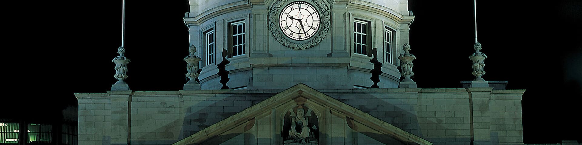front view of an old fashioned building lit up at night