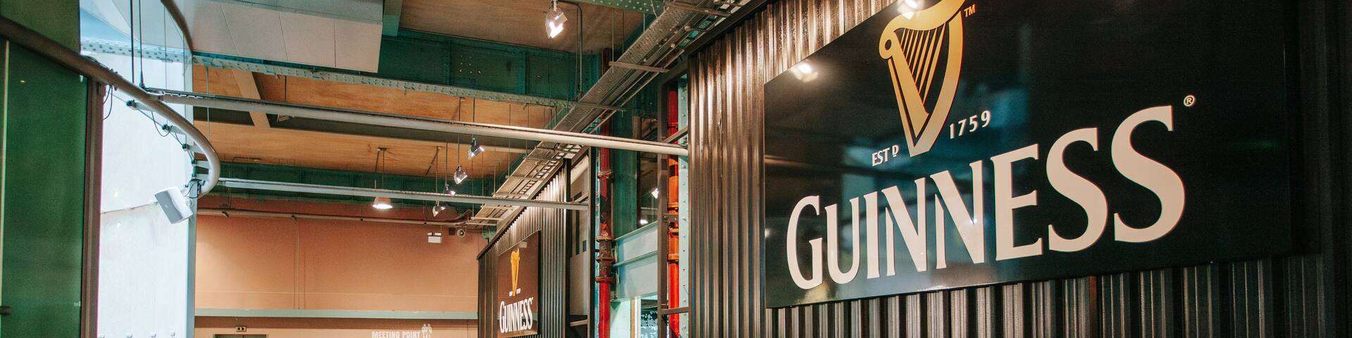 A hallway with a large Guinness sign and a harp logo.