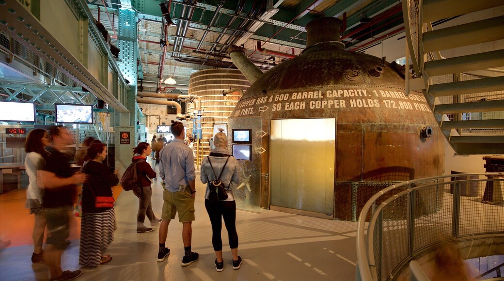 Guinness Storehouse which includes signage and interior views as well as a small group of people