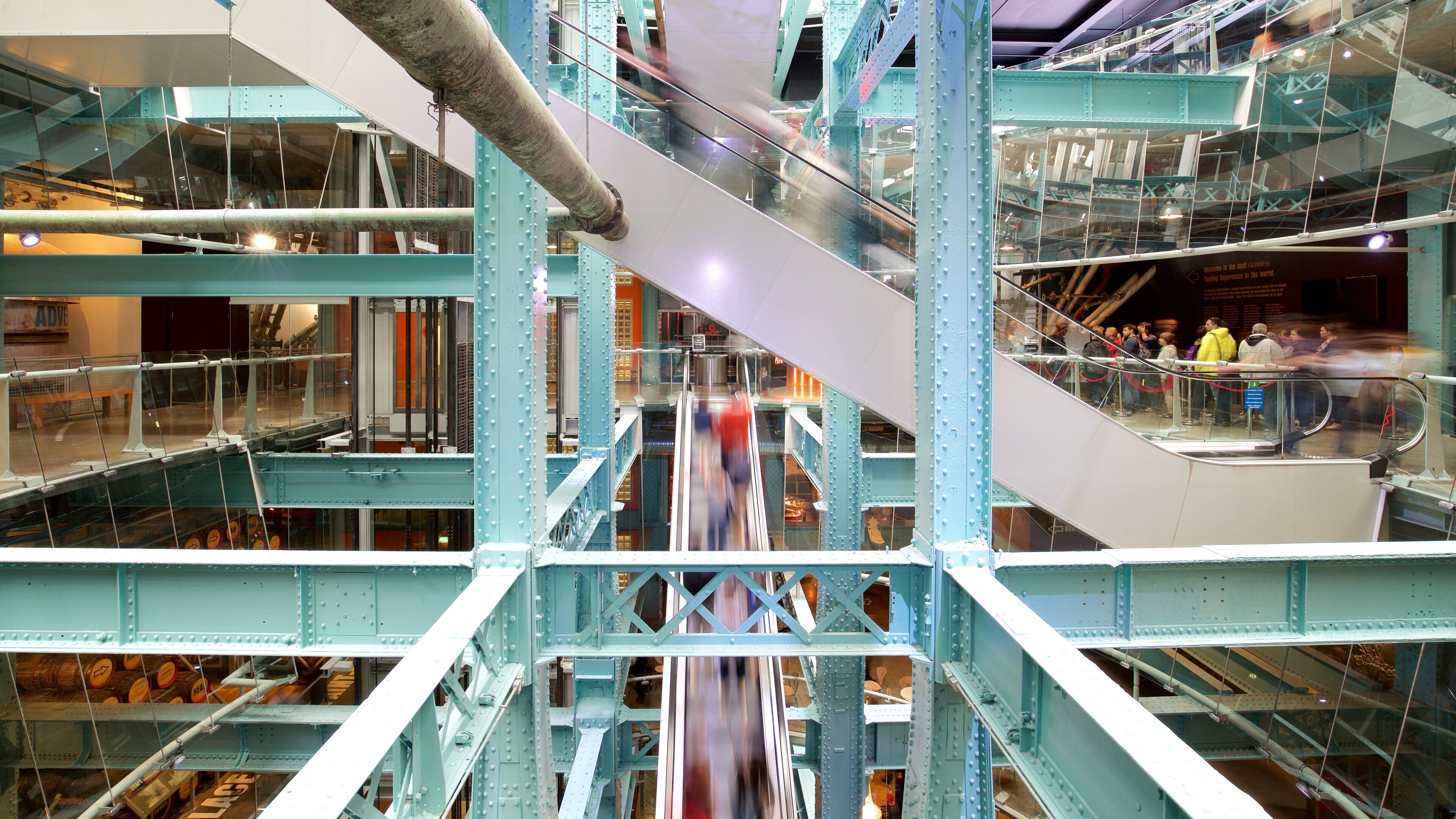 Guinness Storehouse which includes modern architecture and interior views as well as a small group of people