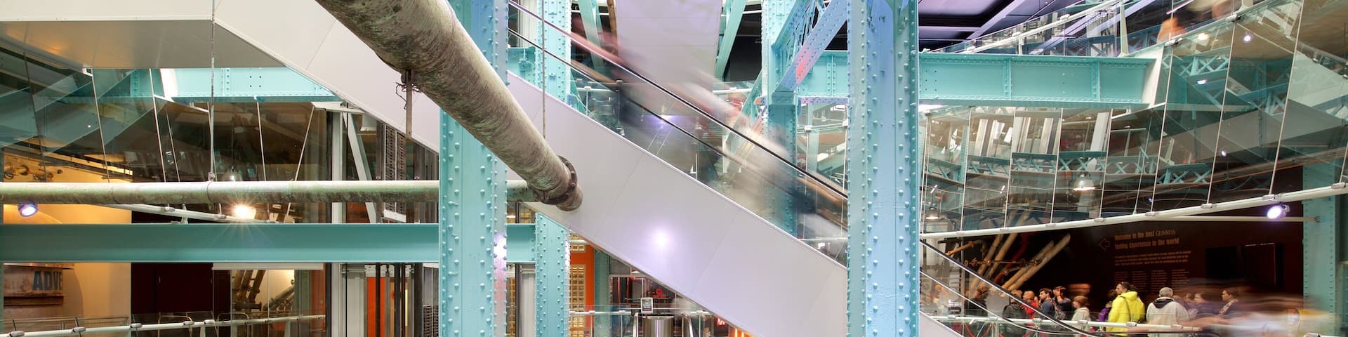 Guinness Storehouse showing modern architecture and interior views as well as a small group of people