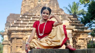 Beautiful indian girl dancer in the posture of Indian odissi dance at Parsurameswara Temple Bhubaneswar, Odisha, India.Indian dance
