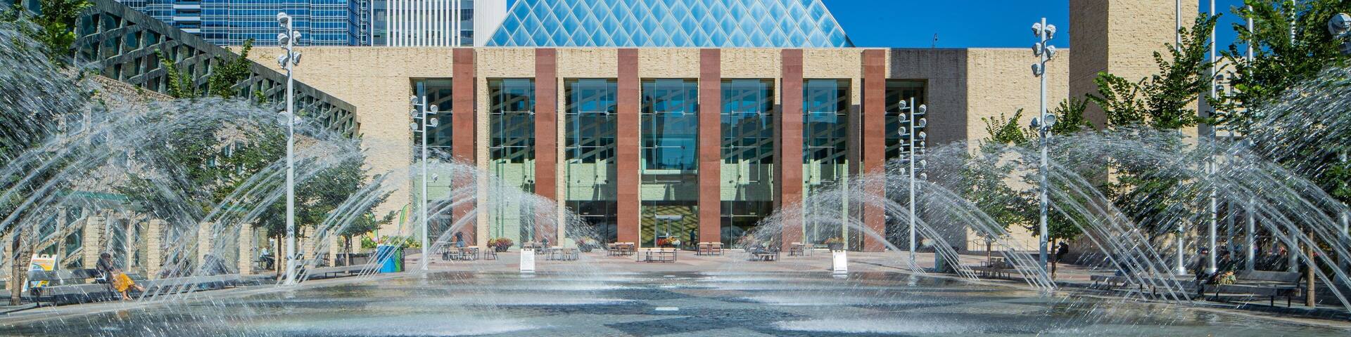 Edmonton City Hall which includes modern architecture, a city and a fountain