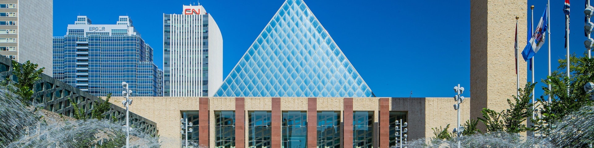 Edmonton City Hall which includes modern architecture, a city and a fountain