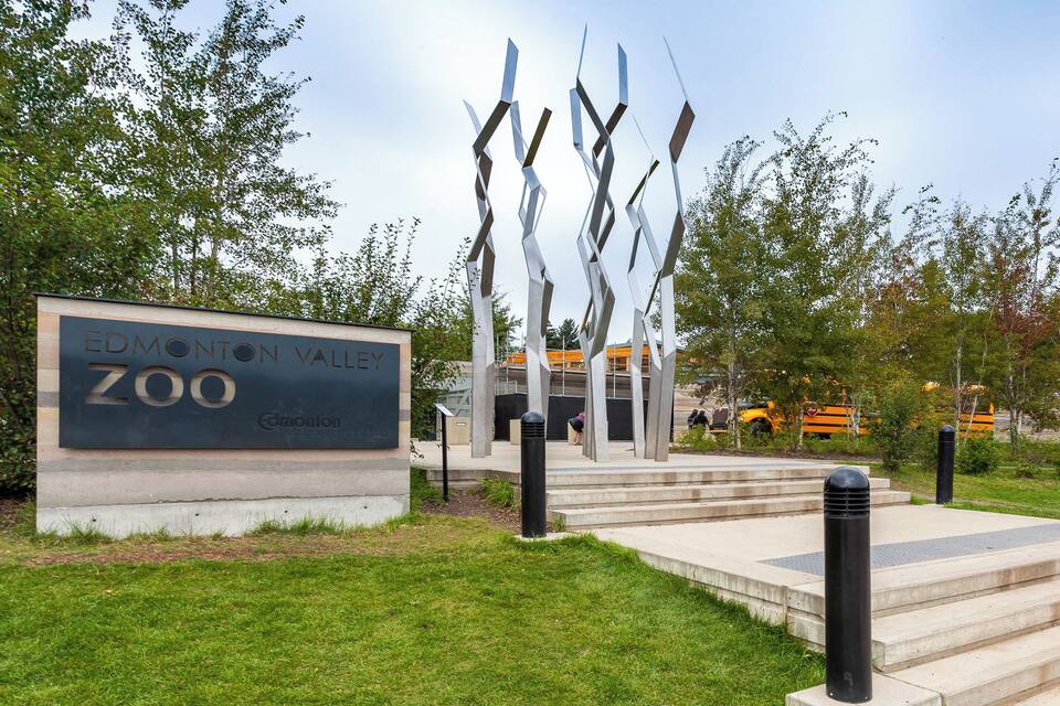 The Edmonton Zoo entrance with a sign and abstract sculptures.