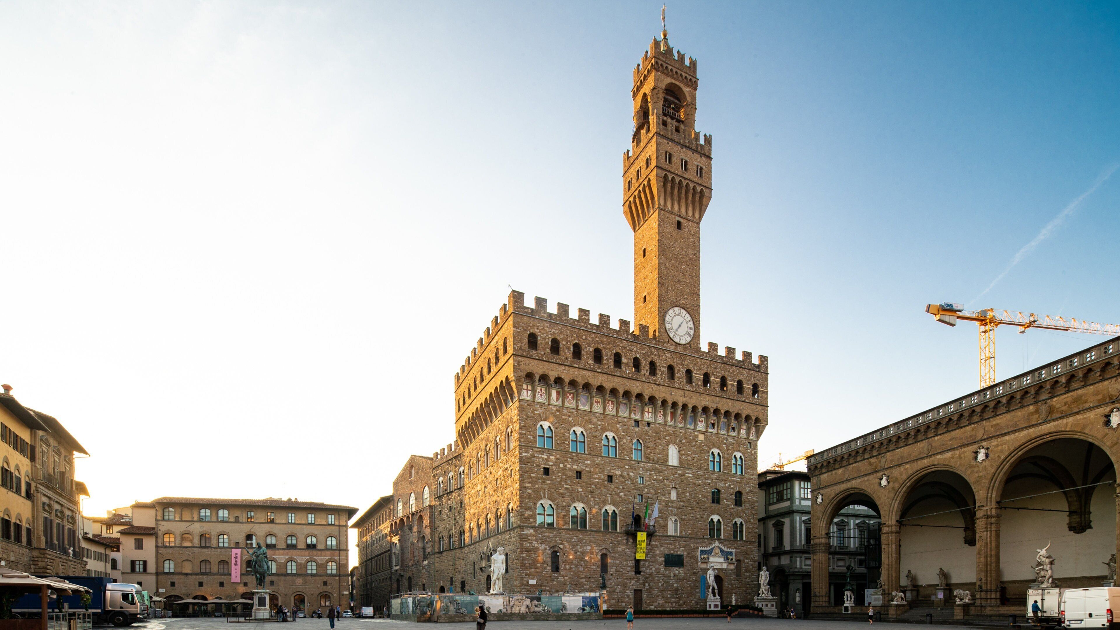 Palazzo Vecchio featuring heritage architecture and a sunset